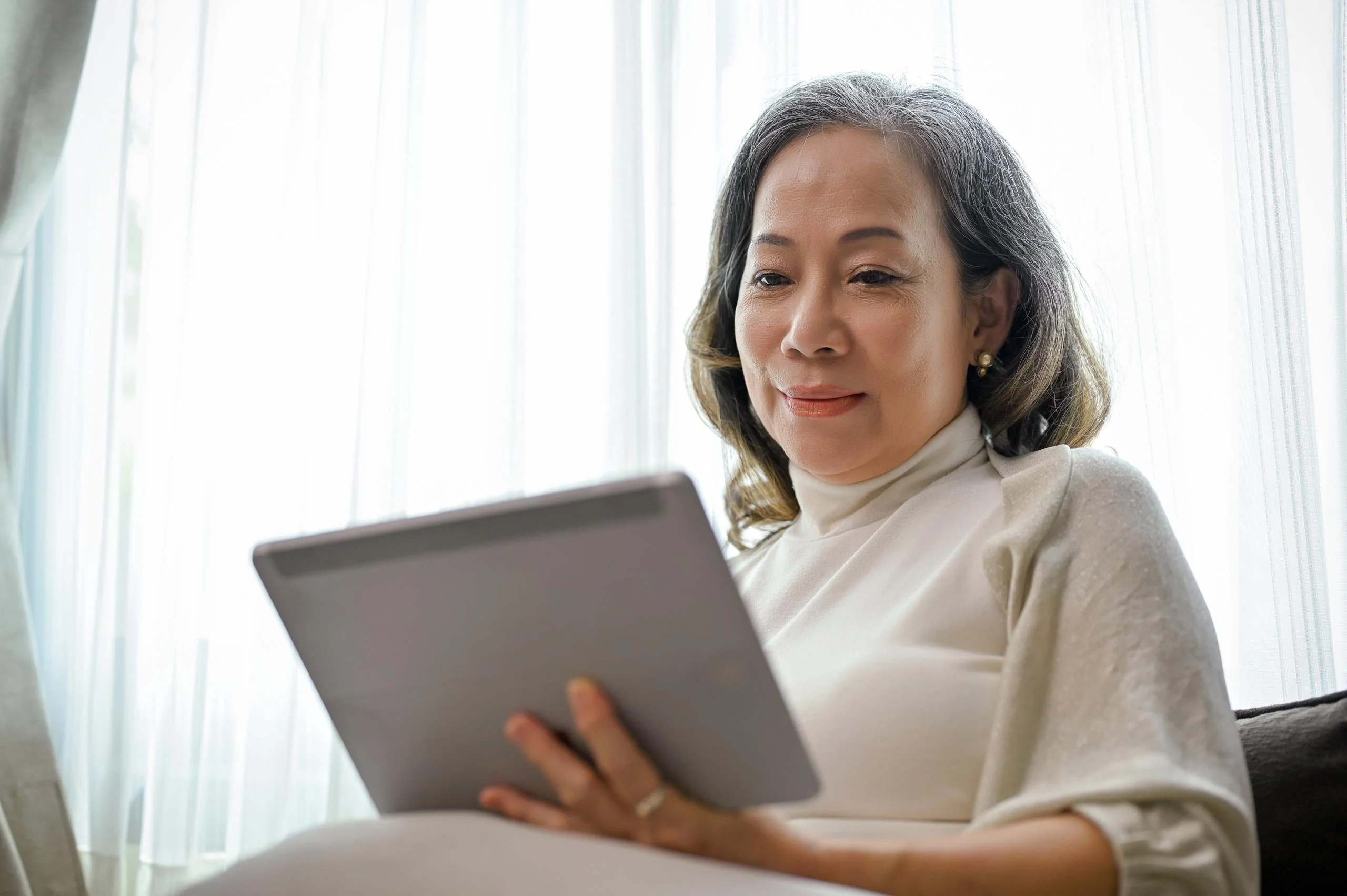 A woman using a tablet computer to donate to Parkinson's research.